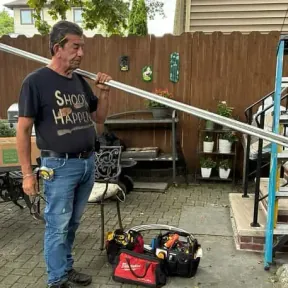 Michael Livia of Premier Electrical Contractors carrying conduit on a job site